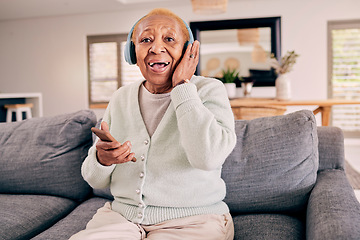 Image showing Headphones, relax and portrait of senior woman on sofa in home listening to music, audio and radio. Retirement, technology and person in living room on phone for streaming track, song or subscription