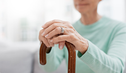 Image showing Hands, walking stick and elderly woman with walking stick on a sofa for balance, support and mobility. Walk, aid and old female at senior care facility with disability, dementia or chronic arthritis