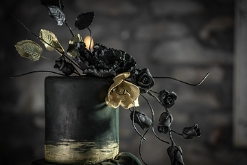 Image showing Dark green toned wedding cake flower decor