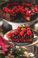 Image showing Slice of chocolate cake with cherry sauce