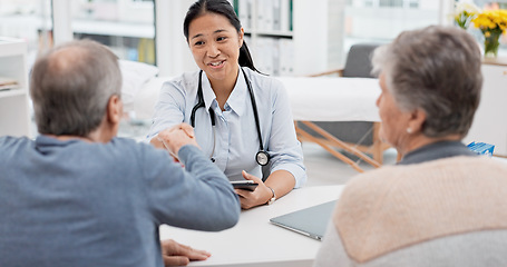 Image showing Doctor consultation meeting, elderly couple and handshake for thank you, welcome and agreement for hospital insurance. Healthcare clinic, senior people and cardiology worker shaking hands for goodbye