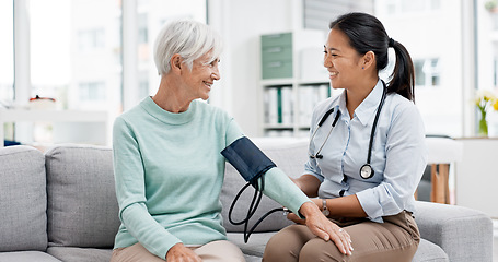 Image showing Doctor, senior patient and blood pressure check with consultation, talking and help, health in hospital office. Women at clinic, communication and cardiovascular healthcare, elderly care and support