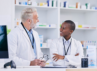 Image showing Discussion, team and pharmacists with medication in pharmacy for healthcare or medical career. Conversation, medicine and senior chemist mentor talking to female pharmaceutical student by dispensary.