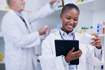 Image showing Pharmacist, woman and tablet for medicine management, reading label and stock research or inventory. Happy doctor with digital technology, healthcare box or product for pharmacy services and support