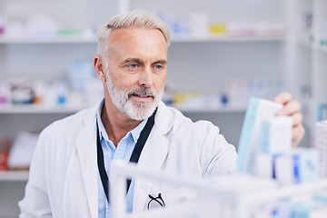 Image showing Pharmacist, man and medicine box for shelf management, reading label and stock research or medical inventory. Senior doctor with healthcare or clinic product for pharmacy, store pills or drugs check