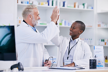 Image showing Pharmacy, high five and teamwork with people in store for medical, success or motivation. Medicine, healthcare and support with man and woman in pills dispensary for community, mentorship or learning