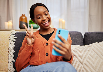 Image showing Selfie, black woman and peace sign at home with a smile for social media, motivation and video call. Photo, happy and African female person in a living room with a v and emoji hand gesture at house