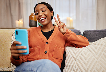 Image showing Selfie, black woman and peace sign at home with a smile for social media, motivation and perfect. Photo, happy and African female person in a living room with a v and emoji hand gesture at house