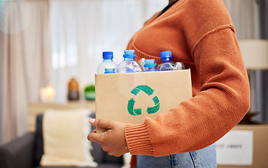 Image showing Plastic, recycling and woman with bottle in box in home for eco friendly, reusable and renewable trash. Sustainability, conservation and person with container to reduce waste, litter and garbage