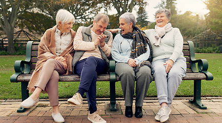 Image showing Conversation, bonding and senior friends in a park sitting on bench for fresh air together. Happy, smile and group of elderly people in retirement in discussion or talking in an outdoor green garden.