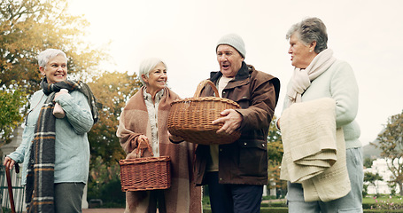 Image showing Walking, picnic and senior friends in the park together for bonding or conversation during retirement. Smile, basket and a group of happy elderly people in a garden for freedom, fresh air to relax