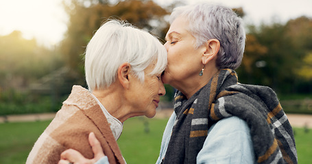 Image showing Senior woman kissing her friend on the forehead for affection, romance and bonding on outdoor date. Nature, commitment and elderly female couple in retirement with intimate moment in garden or park.