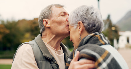 Image showing Kiss, forehead and senior couple in a park with love, happy and conversation with romantic bonding. Kissing, old people and elderly man embrace woman with care, romance or soulmate connection outdoor