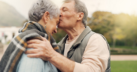 Image showing Kiss, forehead and senior couple in a park with love, happy and conversation with romantic bonding. Kissing, old people and elderly man embrace woman with care, romance or soulmate connection outdoor