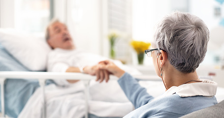 Image showing Hospital, bed and senior couple holding hands, empathy and chat about recovery support, medical problem or rehabilitation. Retirement, clinic bedroom and elderly woman talking to sick cancer patient