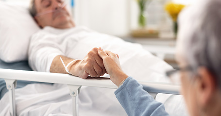 Image showing Hospital, bedroom and senior couple holding hands, empathy and support husband recovery, healthcare problem or rehabilitation. Retirement, comfort or elderly woman care for sick cancer patient in bed
