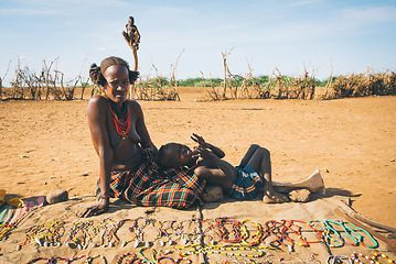 Image showing Dasanesh woman offering handmade souvenirs, Omorate, Omo Valley, Ethiopia