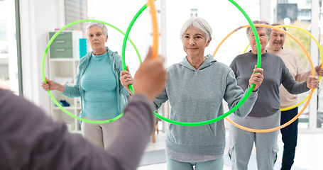 Image showing Fitness, senior and people with hula hoop at the gym for training, workout and health in retirement. Happy, together and a group of elderly friends with a coach and gear for an exercise class