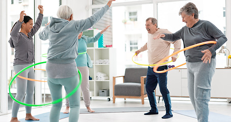 Image showing Fitness, senior and people with hula hoop at the gym for training, workout and health in retirement. Happy, together and a group of elderly friends with a coach and gear for an exercise class