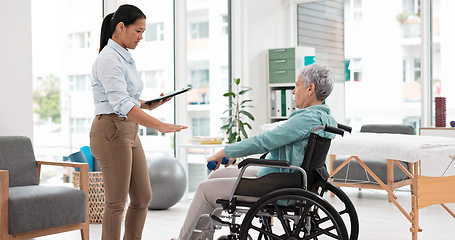 Image showing Woman with disability, physiotherapy and dumbbell rehabilitation of healthcare assessment, test or checklist of healing progress. Physiotherapist, clipboard or consulting senior patient in wheelchair