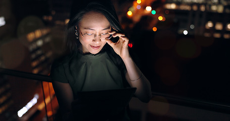 Image showing Glasses, tablet and Asian woman in night office, working late on project deadline or research. Tech, overtime and female employee with touchscreen reading email, report or proposal in dark workplace.