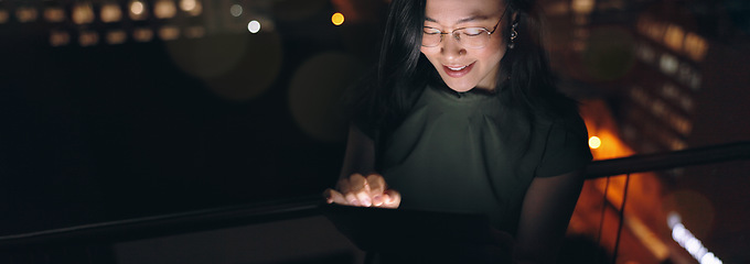 Image showing Woman, digital tablet and rooftop at night in city for social media, research and networking on urban background. Business woman, balcony and online search by entrepreneur working late in New York