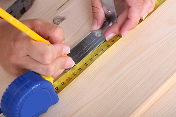 Image showing wooden plank and measuring tape 