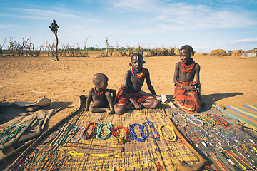 Image showing Dasanesh children offering handmade souvenirs, Omorate, Omo Valley, Ethiopia