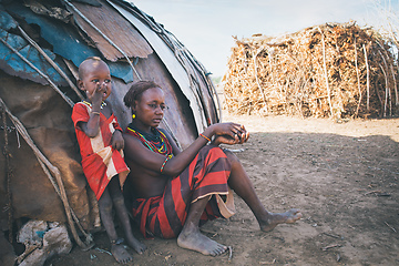 Image showing Dasanesh woman with child in Omorate, Omo Valley, Ethiopia