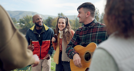 Image showing Singing, camping or happy friends with guitar dancing together in nature, woods or park on vacation. Men, women or fun people with beer or drinks by bonfire or campfire for music in forest on holiday