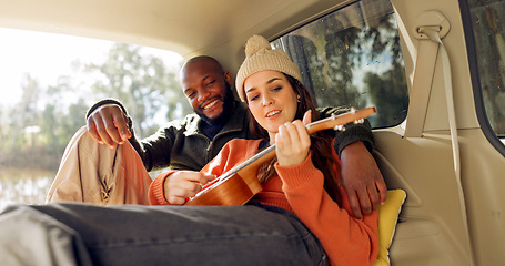 Image showing Singing with Guitar, winter and a couple in a car for a road trip, date or watching the view together. Happy, travel and back of a man and woman with an affection in transport during a holiday or cam