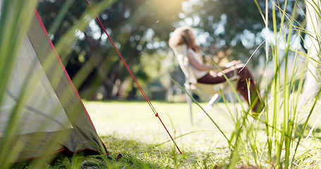 Image showing Nature, camp and woman sitting in a park, forest or the woods in the morning to relax with fresh air. Calm, peace and female person with chair in an outdoor green garden on weekend trip or adventure.