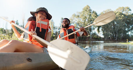 Image showing Couple, kayak and rowing on a lake in nature for sports challenge, adventure or travel with a smile. Young man and woman friends together on boat and water for fitness, travel and holiday for freedom
