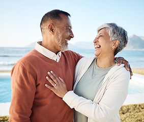 Image showing Beach, laughing and happy senior couple on vacation or holiday together with love in nature at the sea or ocean. Elderly, man and woman relax with happiness, care and smile on retirement bonding