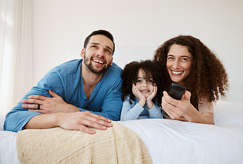 Image showing Bedroom, happy family child and parents watching tv series, movie or streaming online video, cinema or theatre together. Bed, home and relax mom, dad and kid watch cartoon show, television or film