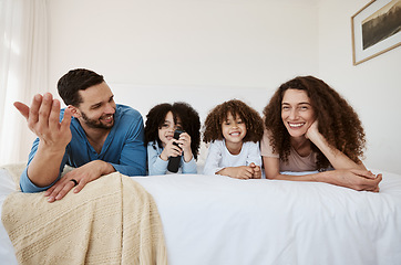 Image showing Bed, happy family children and parents watching tv series, movies or online streaming service, entertainment or video. Bedroom, home and relax mother, father and kids watch show, television or film