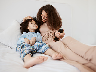 Image showing Bed, happy family child and mom watching tv series, movie and bonding with son, connect and enjoy relax morning. Bedroom, kid and home mother watch cartoon show, television or media entertainment