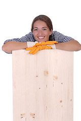 Image showing woman carpenter holding wooden plank