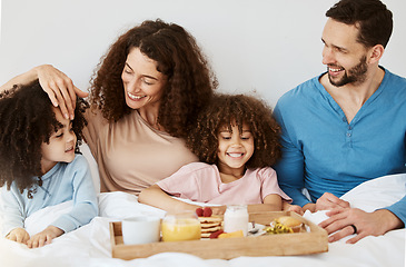 Image showing Parents, children and breakfast in bed, morning or excited for love, bonding or care on holiday. Mother, father and kids in bedroom, food and smile together for nutrition, eating or happy family home