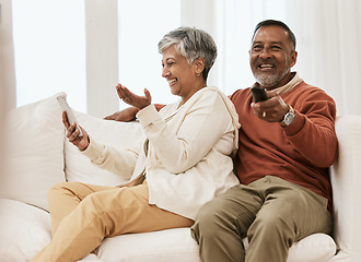 Image showing Laugh, phone and senior couple watching tv series, comedy movie or streaming subscription video, media or funny film. Humour, cellphone and relax elderly people watch television on home lounge sofa