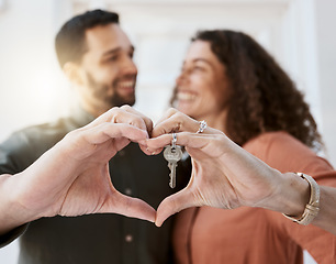 Image showing Heart hands, keys and couple hug for real estate, success or mortgage loan in new home together. Love, emoji and man smile at woman with thank you emoji for realtor, property or deal in dream house