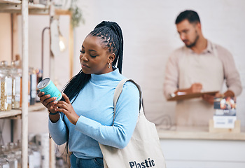 Image showing Shopping, grocery store and black woman by shelf for choice, options and service in eco friendly supermarket. Small business, organic shop and customer reading label for groceries, products and food