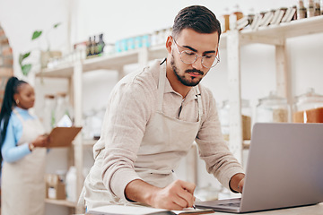 Image showing Man, small business and store for writing, laptop and notes with stock, supply chain and thinking with sustainable ideas. Entrepreneur, partnership and inventory checklist for product, woman and shop