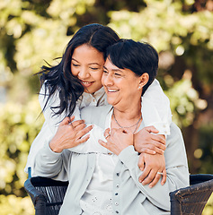 Image showing Mature mother, daughter and hug in garden with love on mothers day or woman bonding with care for mom in retirement. Happy, family and embrace outdoor, backyard or together on holiday or vacation