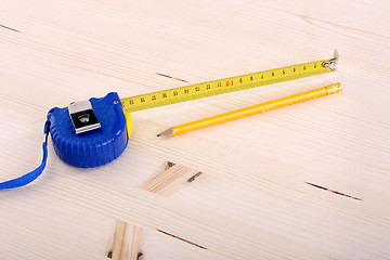 Image showing wooden plank and measuring tape 