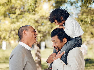 Image showing Senior father, piggyback and child in park for bonding fun, games and trust in backyard garden. Smile, happy and playing dad carrying boy kid on shoulders with parent, family and senior grandfather