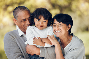 Image showing Family, portrait and hug by child and grandparents in a park with care, bond and fun on blurred background. Love, smile and face of senior people embrace retirement freedom with kid in a forest