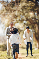 Image showing Child, running and bonding with grandparents in park for fun, energy and summer break in nature. Kid, back and excited boy with senior man and woman on family weekend, activity and backyard games