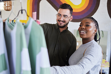 Image showing Retail, store and interracial couple shopping for fashion or style together in a mall and happy for clothes. Customer, man and woman on a date for bonding on vacation or holiday and purchase outfit