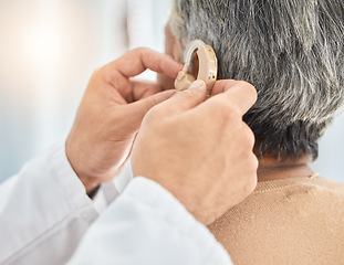 Image showing Hearing aid, senior patient and doctor hand with consultation and medical device. Healthcare, deaf and person with a disability in clinic for solution and professional care in a hospital for support